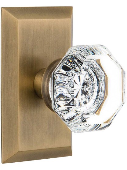 New York Rosette Door Set with Waldorf-Crystal Glass Knobs in Antique Brass.
